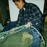 University of West Florida Graduate Hong Potomski, dad working on a shrimp net