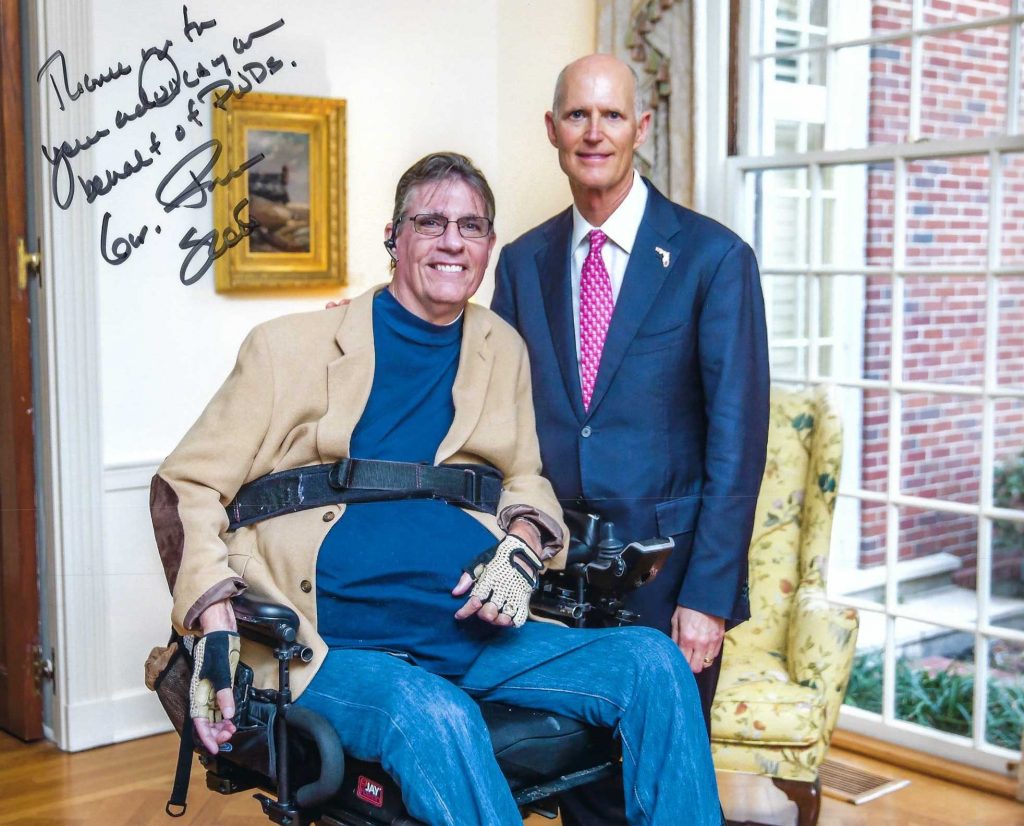 Senator Rick Scott and JR Harding, state disabilities advocate. Signed photo