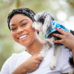 Close-up photo of Praise holding her Yorkie.