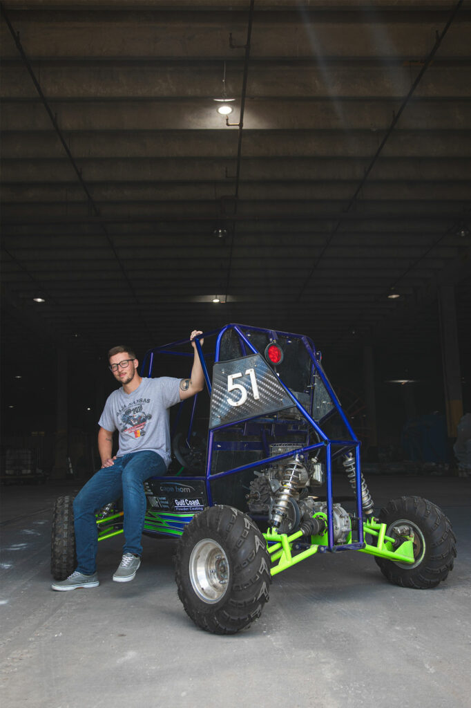 steven thornton with the off-road vehicle that was fabricated by UWF SAE Baja team that he led